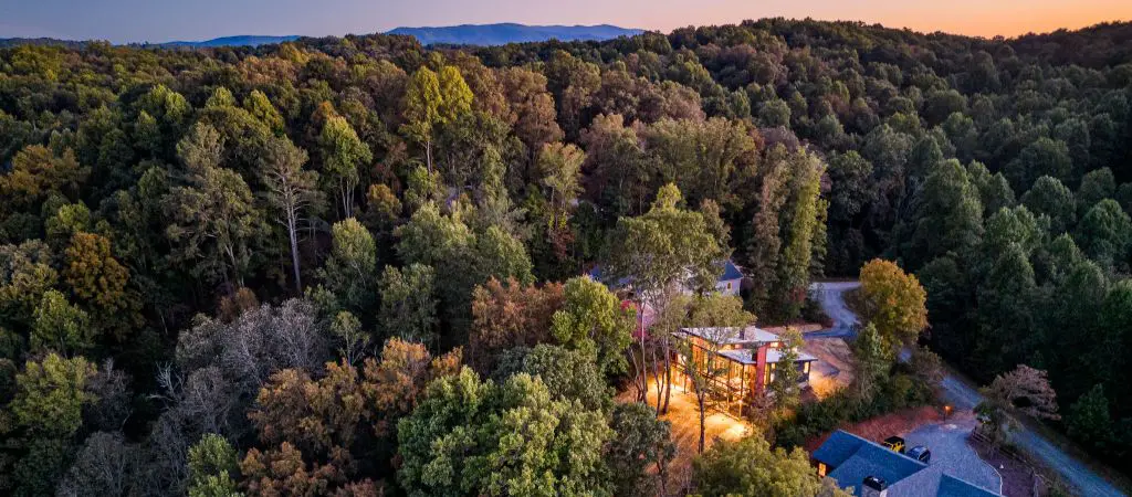 Drone shot of North Georgia cabins at twilight tucked into the Blue Ridge Mountains.